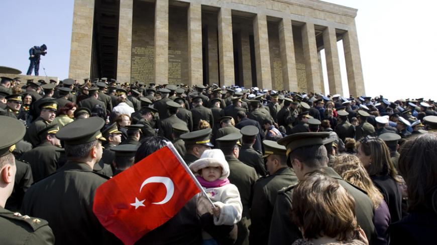 A girl holds a Turkish flag as army officers and their families visit the Anitkabir, mausoleum of the Mustafa Kemal Ataturk, on Martyrs' Day in Ankara March 18, 2007. Ataturk is the revered founder of modern Turkey and the republic's first head of state. REUTERS/Umit Bektas (Turkey) - RTR1NN7T