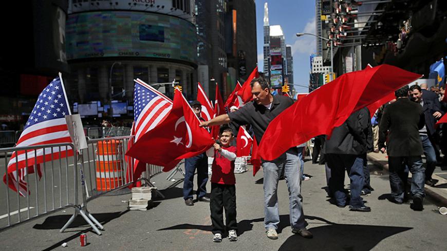 People take part in a protest in support of Turkey's position on the 1915 mass killing of Armenians in the Ottoman Empire, at Times Square in New York April 26, 2014. The exact nature and scale of what happened during fighting that started in 1915 is highly contentious and continues to sour relations between Turkey and Armenia, a former Soviet republic.  Turkey accepts that many Armenians died in clashes, but denies that up to 1.5 million were killed and that this constituted an act of genocide - a term use