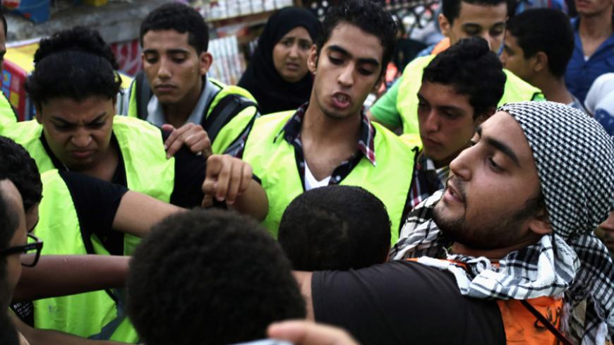 Volunteers from an anti-harassment group called "Harassing the Harasser" detain a young man, after a girl claimed that he was sexually harassing her, during Eid al-Fitr celebrations in central Cairo July 28, 2014.  Police and volunteers of anti-harassment groups have been more active since last month's incident of a woman who was sexually assaulted by a mob during celebrations marking the inauguration of President Abdel Fattah al-Sisi, according to local authorities.   REUTERS/Asmaa Waguih (EGYPT - Tags: CI