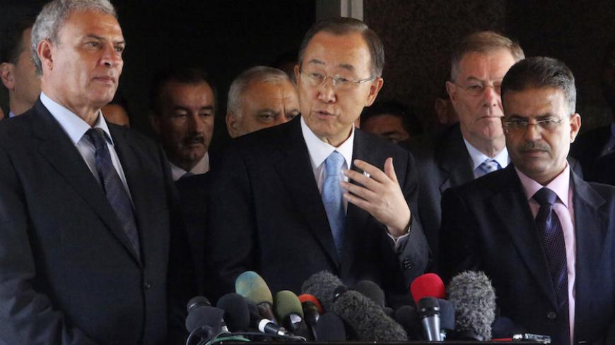 United Nations Secretary-General Ban Ki-moon (C) speaks to the media during his visit to the headquarters of the Palestinian cabinet in Gaza City October 14, 2014. Ban Ki-moon lamented the vast destruction in Gaza as he visited the area on Tuesday for the first time since the war, calling the situation "beyond description" and urging a speedy reconstruction effort. He also announced that Israel was permitting a first truckload of construction materials to enter the enclave, which has been blockaded by Israe