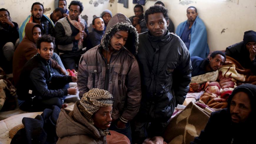 Illegal migrants sit in an immigration holding centre located on the outskirts of Misrata March 11, 2015. Italy wants Egypt and Tunisia to play a role in rescuing stricken migrant vessels in the Mediterranean, a government planning paper showed, so that survivors could be taken back to African instead of European ports. Last April Italy rescued 4,000 migrants from boats trying to reach European shores in only 48 hours in a deepening immigration crisis that is being made worse by the turmoil in Libya, which 