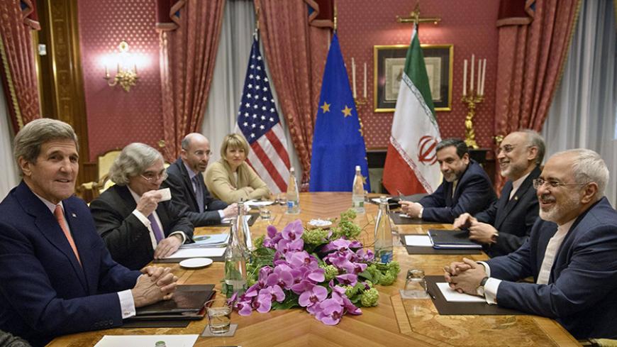 U.S. Secretary of State John Kerry (L), U.S. Secretary of Energy Ernest Moniz (2nd L), the head of the Iranian Atomic Energy Organization Ali Akbar Salehi (2nd R) and Iranian Foreign Minister Javad Zarif (R) wait with others for a meeting at the Beau Rivage Palace Hotel March 28, 2015, in Lausanne. Iran and major powers are close to agreement on a 2- or 3-page accord with specific numbers that would form the basis of a long-term settlement aimed at ending a 12-year standoff over Tehran's nuclear ambitions, 
