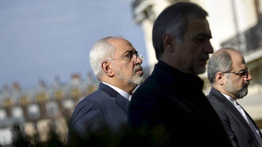 Iranian Foreign Minister Javad Zarif (L) walks in a courtyard at the Beau Rivage Palace Hotel in Lausanne on March 28, 2015 during talks over Iran's nuclear programme. REUTERS/Brendan Smialowski/Pool - RTR4V95P