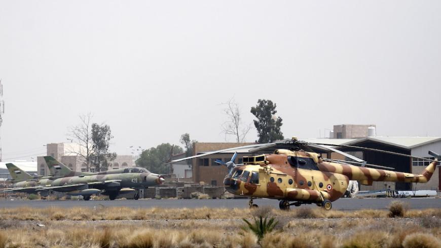 Yemeni Air Force MiG-21 fighters and a Mil Mi-17 helicopter are seen at an air base near Sanaa Airport March 28, 2015. REUTERS/Khaled Abdullah - RTR4V9D4