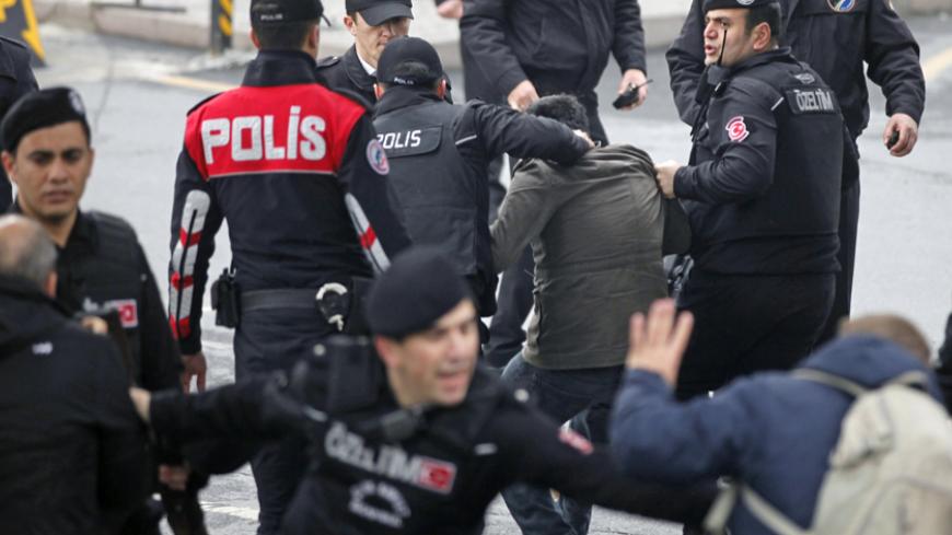 Turkish riot police detain a protester outside the Justice Palace in Istanbul March 31, 2015. A far-left Turkish group took an Istanbul prosecutor hostage on Tuesday and threatened to kill him, prompting special forces to enter the courthouse and police to evacuate the building. REUTERS/Osman Orsal - RTR4VM35