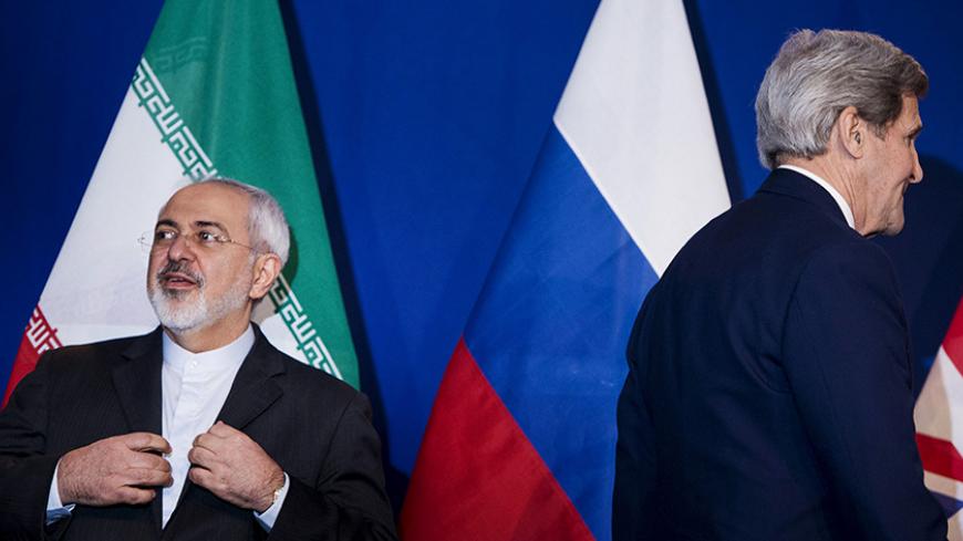 Iranian Foreign Minister Javad Zarif (L) waits to make a statement next to U.S. Secretary of State John Kerry (R), following nuclear talks at the Swiss Federal Institute of Technology in Lausanne (Ecole Polytechnique Federale De Lausanne) April 2, 2015. Iran and world powers reached a framework on curbing Iran's nuclear programme at marathon talks in Switzerland on Thursday that will allow further negotiations towards a final agreement. REUTERS/Brendan Smialowski/Pool - RTR4VXHZ