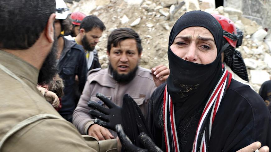 A woman reacts while civil defence members carry her dead child after what activists said was shelling by warplanes loyal to Syria's president Bashar Al-Assad in Aleppo's rebel-controlled Bab Al-Nairab district April 12, 2015. REUTERS/Abdalrhman Ismail  - RTR4X059