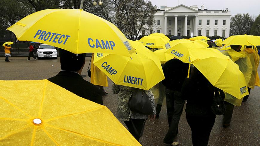 Supporters of residents of the Mujahadin-e-Khalq (MEK) camp, which houses Iranian dissidents in western Baghdad, rally on Pennsylvania Avenue as U.S. President Barack Obama meets with Iraq's Prime Minister Haider Al-Abadi at the White House in Washington April 14, 2015. The dissidents, who call for the overthrow of Iran's clerical leaders and fought on Iraq's side during the Iran-Iraq war in the 1980s, occupy "Camp Liberty", located in a former U.S. military compound in Baghdad, but is no longer welcome in 