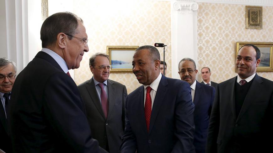 Russian Foreign Minister Sergei Lavrov (2nd L) shakes hands with Libya's internationally recognized Prime Minister Abdullah al-Thinni (C) ahead of their meeting in Moscow April 15, 2015. REUTERS/Maxim Shemetov - RTR4XGB6
