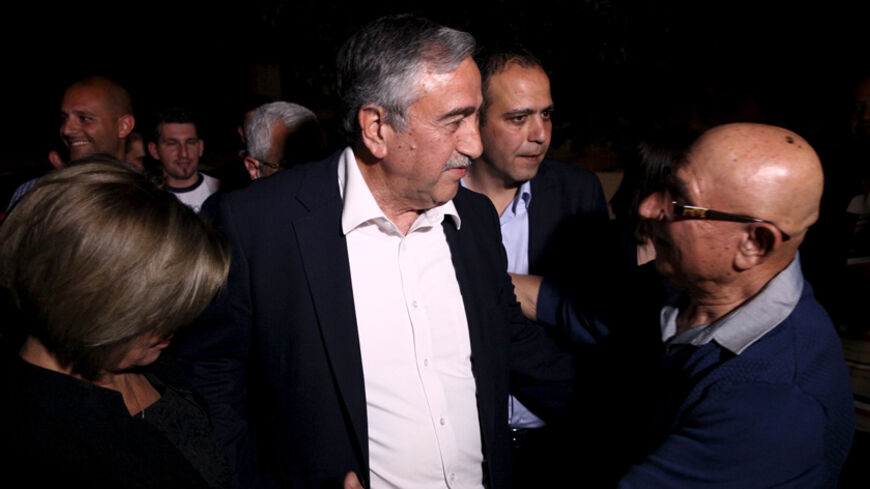 A supporter greets Turkish Cypriot politician Mustafa Akinci after the presidential elections in Nicosia April 19, 2015. Akinci will move to a second round of leadership elections in north Cyprus  after a vote on Sunday failed to produce a clear winner. REUTERS/Yiannis Kourtoglou  - RTR4XXFR