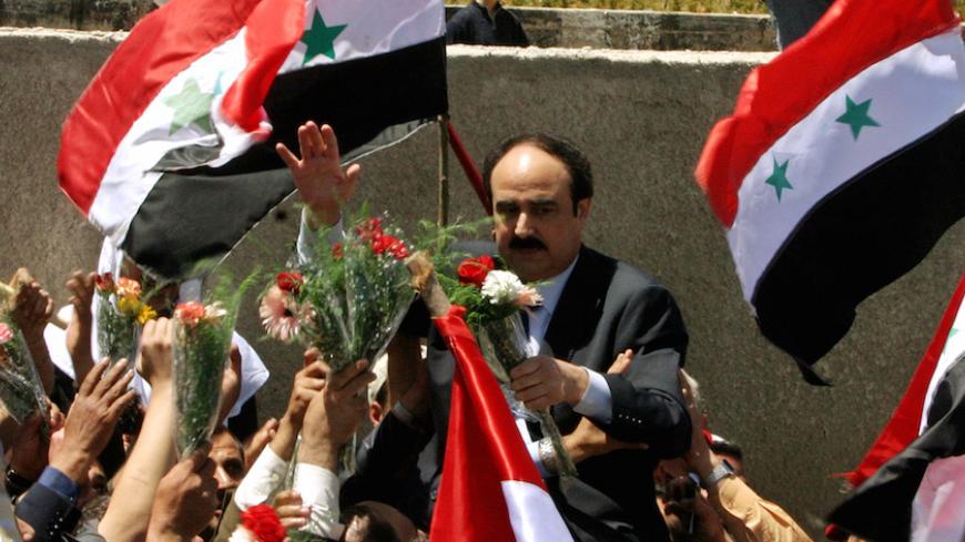 Syrians carry returning intelligence chief in Lebanon, Rustum Ghazaleh, in Damascus April 26, 2005. The last Syrian soldiers and intelligence agents left Lebanon on Tuesday, ending three decades of Syria's direct involvement in its small neighbour. As their buses crossed the frontier, many Lebanese hailed the completion of a withdrawal that had taken seven weeks as the start of a new era. But although Damascus's domination is past, many believe its influence in Lebanon is far from over. REUTERS / Khaled al-