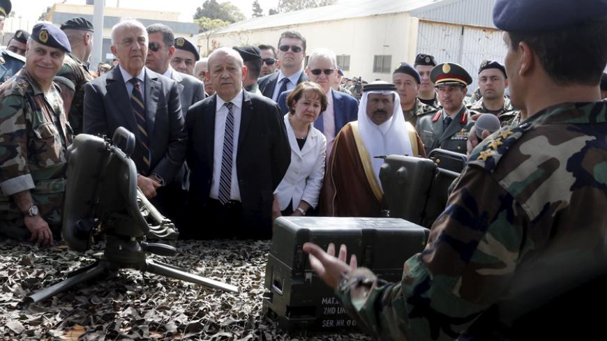 (From L to R) Lebanon's army chief General Jean Kahwaji, Lebanese Deputy Prime Minister and Defense Minister Samir Moqbel and French Defense Minister Jean-Yves Le Drian review weapons given to the Lebanese army at Beirut airport airbase April 20, 2015. The first shipment of French weapons and military equipment arrived in Lebanon on Monday under a Saudi-funded deal worth $3 billion to bolster the Lebanese army's fight against militants encroaching from neighboring Syria. REUTERS/Mohamed Azakir  - RTX19H1M