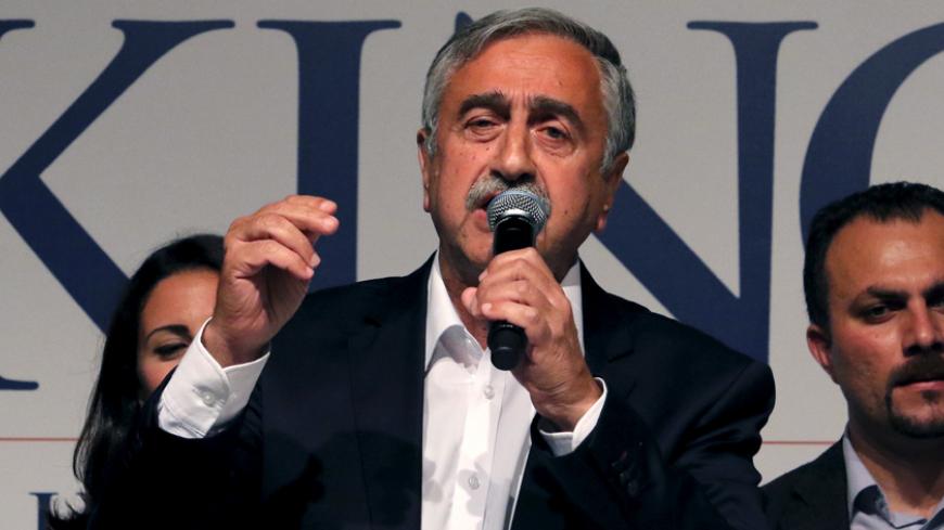 Turkish Cypriot politician Mustafa Akinci delivers a speech to supporters after his election victory in Nicosia, April 26, 2015. Mustafa Akinci, standing as an independent, won 60.3 percent of the votes, according to figures provided by the election commission. His rival was incumbent president Dervis Eroglu, a conservative elected five years ago. REUTERS/Yiannis Kourtoglou  - RTX1ADHX
