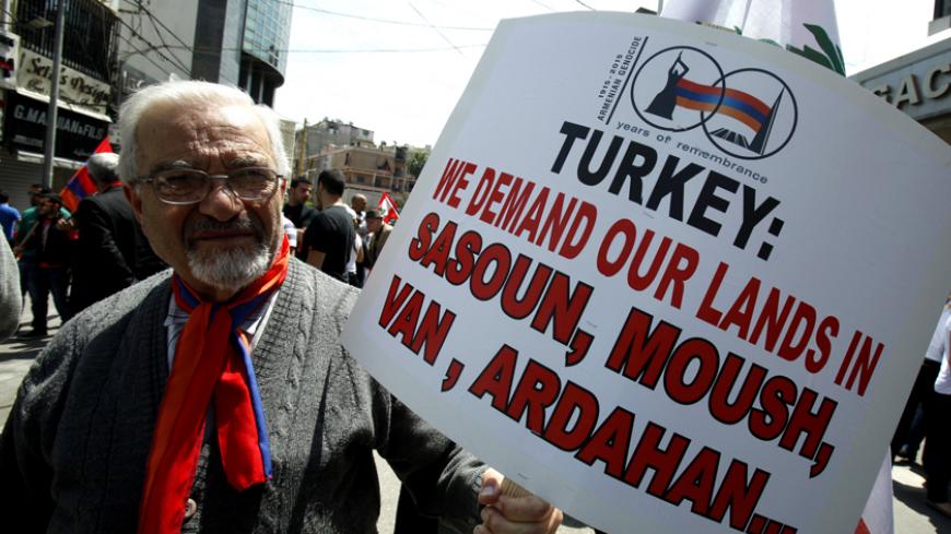 A Lebanese man of Armenian descent holds a sign during a march from Bourj Hammoud to downtown Beirut's Martyrs Square, April 24, 2013, to mark the 98th anniversary of the mass killing of Armenians in the Ottoman Empire in 1915. REUTERS/Sharif Karim (LEBANON - Tags: POLITICS CIVIL UNREST ANNIVERSARY) - RTXYXZD