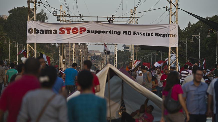 Egyptian demonstrators gather outside the presidential palace in Cairo during a protest calling for the ouster of President Mohamed Morsi on July 1, 2013. Egypt's armed forces warned that it will intervene if the people's demands are not met within 48 hours, after millions took to the streets to demand the president's resignation. AFP PHOTO / KHALED DESOUKI        (Photo credit should read KHALED DESOUKI/AFP/Getty Images)
