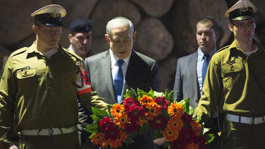 JERUSALEM, ISRAEL - APRIL 16:  (ISRAEL OUT) In this handout from the Israeli GPO, Prime Minister Benjamin Netanyahu lays a wreath during a ceremony to mark Holocaust Remembrance Day at the Yad Vashem Museum on April 16, 2015 in Jerusalem, Israel. Traffic stopped and people stood to attention as a two minutes silence was observed in Israel, with sirens sounding across the country to mark the annual Holocaust Remembrance Day. (Photo by Amos Ben Gershom/GPO via Getty Images)