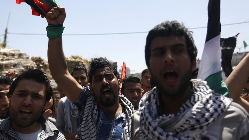 Palestinians chant slogans during a protest in Gaza City on April 29, 2015, organized by the Palestinian Youth Organization, calling for an end to political division, the re-opening of the Rafah crossing border and the reconstruction of destroyed houses that were damaged in the 50-day war between Israel and Hamas militants in the summer of 2014. AFP PHOTO / MOHAMMED ABED        (Photo credit should read MOHAMMED ABED/AFP/Getty Images)
