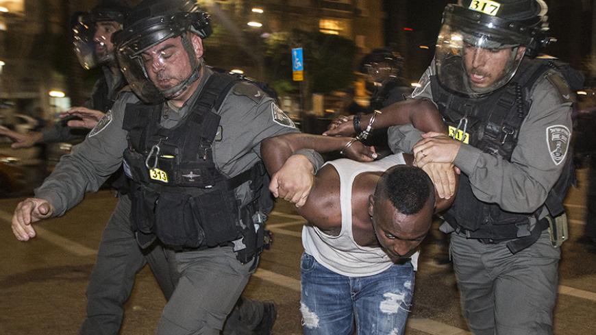 Israeli security forces arrest an Israeli man from the Ethiopian community in the coastal city of Tel Aviv, on May 3, 2015, during a protest against alleged police brutality and institutionalised discrimination. The protest came three days after a stormy demonstration in Jerusalem sparked by footage showing two police officers beating an Israeli soldier of Ethiopian origin in uniform. More than 135,000 Ethiopian Jews live in Israel, having immigrated to the Jewish state in two waves in 1984 and 1991. AFP PH