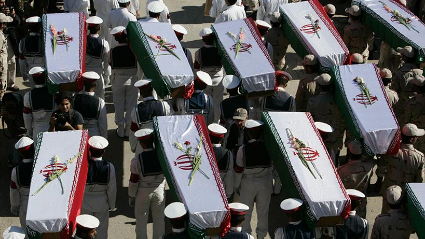 Pallbearers carry the remains of Iranian soldiers during a ceremony at the Iraq-Iran Shalamcha Border Crossing, in southern Iraq November 30, 2008. Iraq returned to neighbouring Iran the remains of 41 Iranian soldiers killed during the 1980's Iraq-Iran war in exchange for the remains of Iraqi soldiers on Sunday, Iraqi officials said.   REUTERS/Atef Hassan (IRAQ) - RTR2245W