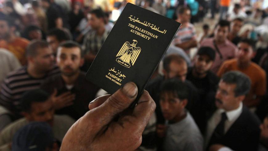 A passenger hands back passports to Palestinians waiting to cross into Egypt at the Rafah border crossing in the southern Gaza Strip June 1, 2010. Egypt opened its border with the Gaza Strip on Tuesday, letting Palestinians cross until further notice amid a storm of international criticism of Israel's blockade of the enclave, officials in Egypt and Gaza said. REUTERS/Mohammed Salem (GAZA - Tags: POLITICS) - RTR2EN6J