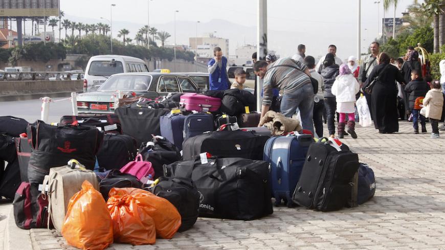 Syrian refugees wait with their luggage and belongings outside a hotel in Beirut to be transported by buses to Beirut international airport for resettlement in Germany April 15, 2014. About 300 Syrian refugees departed early morning from Beirut to Germany on a private chartered flight where they will be offered resettlement, UNHCR, which has been assisting the refugees in Lebanon, said. REUTERS/Sharif Karim     (LEBANON - Tags: CIVIL UNREST POLITICS SOCIETY IMMIGRATION) - RTR3LBDE
