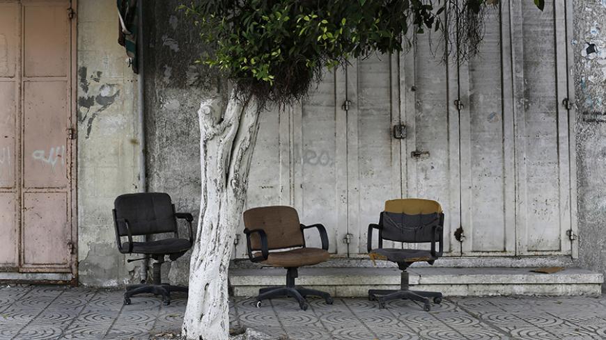 Office chairs sit abandoned in front of shuttered store fronts along a normally bustling commercial street in central Gaza City, July 19, 2014. Israel's month-long war against Hamas, with Israel carrying out air strikes, artillery bombardments and ground operations in response to constant militant rocket fire and attacks via tunnels, left more than 2,000 Palestinians dead, most of them civilians, as well as 64 Israeli soldiers and three civilians. It was the deadliest war in Gaza since Israel unilaterally w