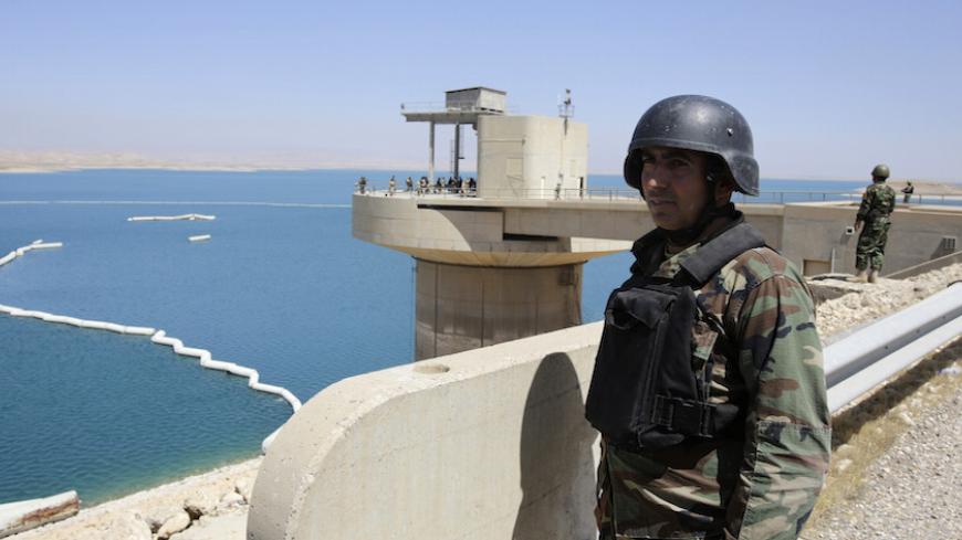Peshmerga fighters stand guard at Mosul Dam in northern Iraq August 21, 2014. Despite its structural faults, the country's biggest dam at 3.6 km long, built by a German-Italian consortium in the 1980s, is a vital water and power source for Mosul, Iraq's largest northern city of 1.7 million residents. Control the dam and you control the 'keys' to the city. With that in mind, Islamic State insurgents who captured swathes of Iraq and Syria and declared a caliphate, wrested control of the dam from Kurdish force