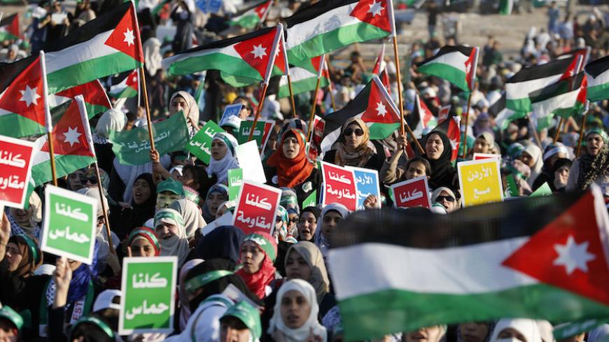 Supporters of the Jordanian Muslim Brotherhood take part in a rally in Amman, celebrating what Hamas say is its victory in Gaza, August 29, 2014. Tens of thousands of the Brotherhood's supporters took part in the celebrations after an open-ended ceasefire, mediated by Egypt, took effect on  Tuesday evening between Israel and Palestinian militant groups in the Gaza Strip. Hamas presented the truce as a victory for the Palestinian people. REUTERS/Muhammad Hamed (JORDAN - Tags: POLITICS CIVIL UNREST CONFLICT) 