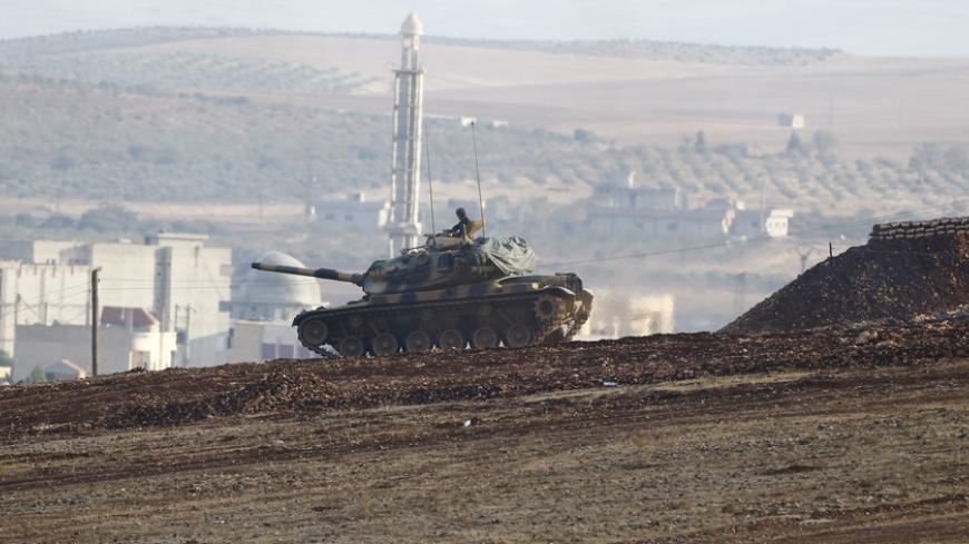 Turkish army tank takes position near Mursitpinar border crossing on the Turkish-Syrian border in the southeasternTurkish town of Suruc in Sanliurfa provincee, October 18, 2014. A U.S.-led military coalition has been bombing Islamic State fighters who hold a large swathe of territory in both Iraq and Syria, two countries involved in complex multi-sided civil wars in which nearly every country in the Middle East has a stake..    REUTERS/Kai Pfaffenbach (TURKEY  - Tags: MILITARY POLITICS CONFLICT)   - RTR4ANT