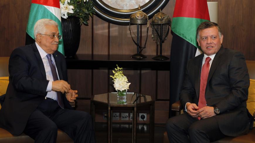 Jordan's King Abdullah (R) meets with Palestinian President Mahmoud Abbas at the Royal Palace in Amman November 12, 2014. REUTERS/Majed Jaber (JORDAN - Tags: POLITICS ROYALS) - RTR4DV07