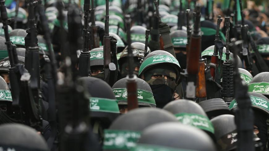 Palestinian members of al-Qassam Brigades, the armed wing of the Hamas movement, take part in a military parade marking the 27th anniversary of Hamas' founding, in Gaza City December 14, 2014.  REUTERS/Mohammed Salem (GAZA - Tags: POLITICS MILITARY ANNIVERSARY) - RTR4HY1G