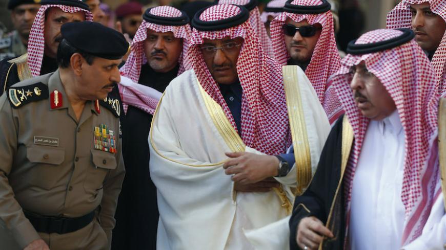 Prince Mohammed bin Nayef (C), Saudi Deputy Crown Prince, takes part in the funeral of Saudi King Abdullah bin Abdulaziz in Riyadh January 23, 2015. King Abdullah bin Abdulaziz died early on Friday and his brother Salman became king of the world's top oil exporter. King Salman moved swiftly to appoint Mohammed Deputy Crown Prince on Friday, hours after he took the throne following the death of King Abdullah. REUTERS/Faisal Al Nasser (SAUDI ARABIA - Tags: ROYALS RELIGION OBITUARY) - RTR4MMDK
