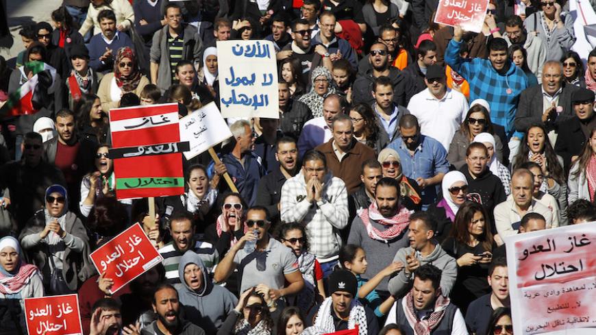 Jordanian protesters take part in a march against a government agreement to import natural gas from Israel, in Amman March 6, 2015. The red placards read "The enemy's gas is occupation".  REUTERS/Majd Jaber (JORDAN - Tags: POLITICS ENERGY CIVIL UNREST BUSINESS) - RTR4SBDC
