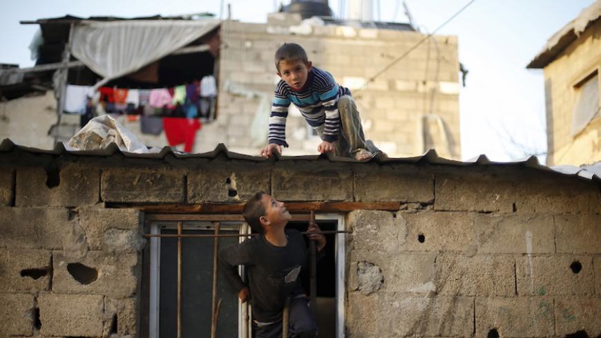 Palestinian boys play at their family house in Biet Lahiya town in the northern Gaza Strip March 24, 2015. REUTERS/Mohammed Salem 







 - RTR4UP0K