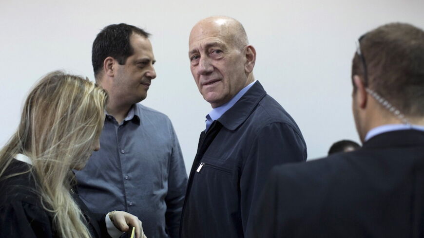 Former Israeli Prime Minister Ehud Olmert (3rd L) waits to hear his verdict at Jerusalem District Court March 30, 2015. Olmert, already facing a six-year prison term after a corruption conviction, was found guilty on Monday in a separate case of accepting illegal payments from a U.S. businessman.  REUTERS/Abir Sultan/Pool      TPX IMAGES OF THE DAY      - RTR4VF21