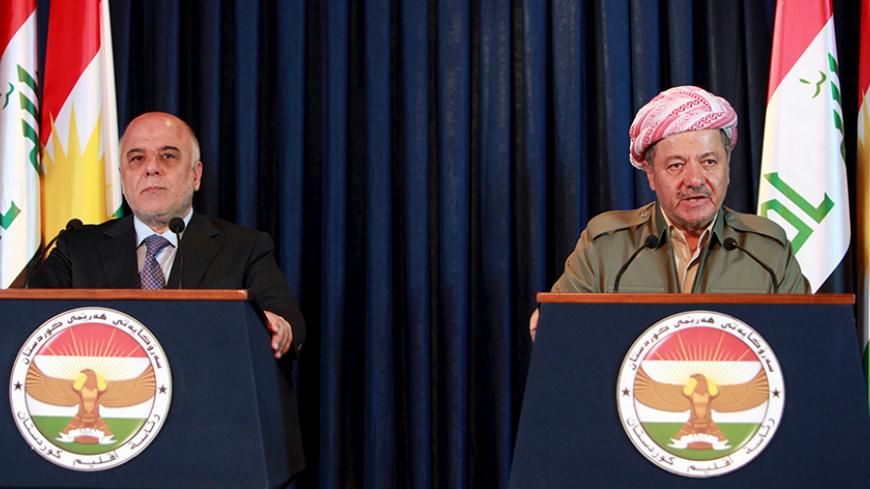 Iraqi Kurdish President Massoud Barzani (R) addresses the media during a joint news conference with Iraqi Prime Minister Haider al-Abadi in Arbil, April 6, 2015. Abadi said the Baghdad government would work with Kurdish authorities to liberate the northern province of Nineveh from Islamic State militants. REUTERS/Azad Lashkari - RTR4W8W5