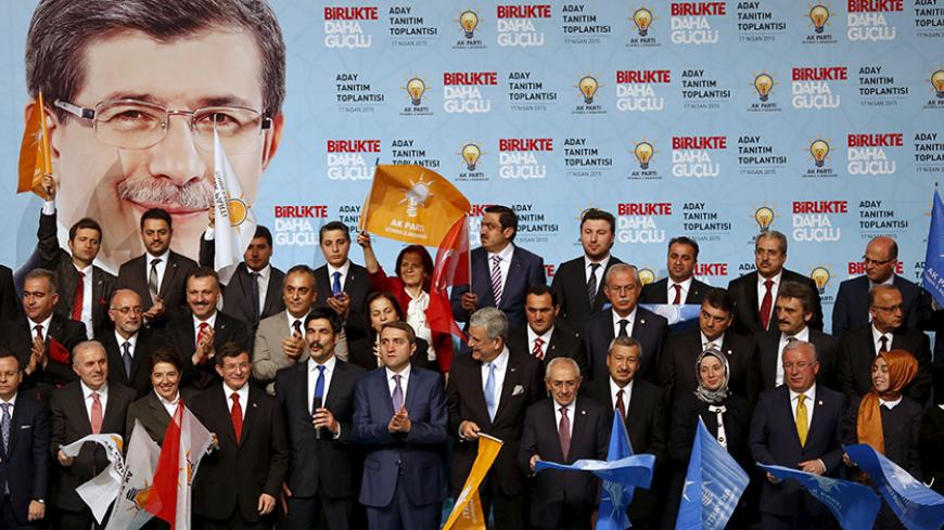 Turkey's Prime Minister Ahmet Davutoglu (front row, 4th L) poses with his AK Party Istanbul candidates for the upcoming general elections, during a presentation in Istanbul April 17, 2015. REUTERS/Murad Sezer - RTR4XRJT
