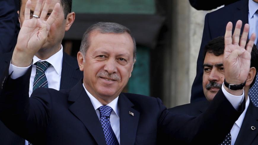Turkey's President Tayyip Erdogan greets his supporters in front of a mosque after Friday prayers in Istanbul, Turkey, May 29, 2015. Erdogan said the launch of Ziraat Bank's Islamic business should help to attract new funds to Turkey and urged other state lenders to help to triple Islamic banking's share of the market by 2023. Islamic finance has developed slowly in Turkey, the world's eighth most populous Muslim nation, partly because of political sensitivities and the secular nature of its laws. However, 