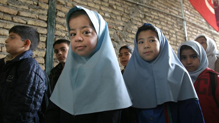 Afghan children wait to enter school for the second shift of classes at a small private school for Afghans south of Tehran.  Afghan children wait to enter school for the second shift of classes at a small private school for Afghans south of Tehran January 17, 2004. Iran's Bureau for Immigrants on Monday denied U.N accusations of sending Afghan refugees home against their will. REUTERS/Raheb Homavandi - RTRKRI8