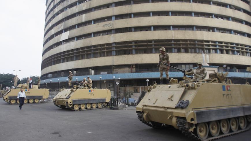 Soldiers stand on an armoured personnel carrier positioned outside the state-run television station in Cairo July 6, 2013.    REUTERS/Khaled Abdullah (EGYPT - Tags: POLITICS CIVIL UNREST MILITARY MEDIA) - RTX11E7B