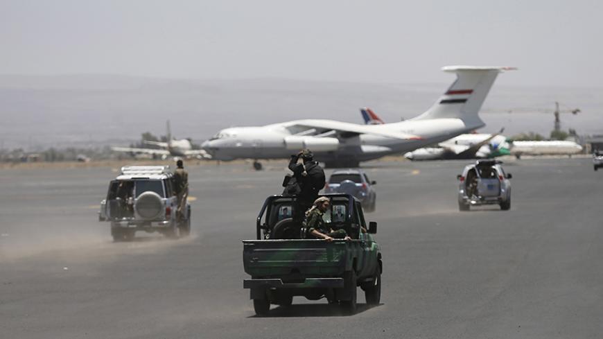 Houthi militants ride on a patrol truck at the international airport of Yemen's capital Sanaa, April 29, 2015. Jets from a Saudi-led alliance destroyed the runway of Yemen's Sanaa airport on Tuesday to prevent an Iranian plane from landing there, Saudi Arabia said, as fighting across the country killed at least 30 people. Airport officials said the strikes set a civilian aircraft operated by Yemeni Felix Airways ablaze. REUTERS/Khaled Abdullah - RTX1ATYY