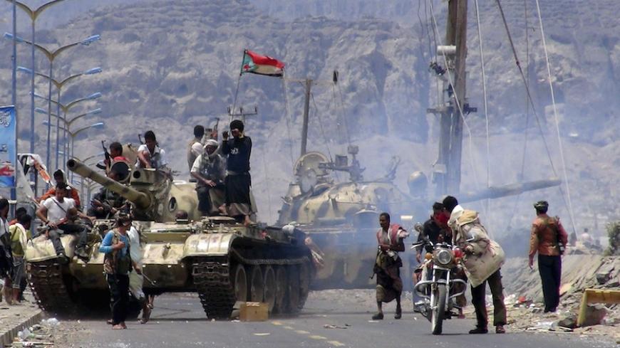 Southern Popular Resistance fighters gather on a road during fighting against Houthi fighters in Yemen's southern city of Aden May 3, 2015. Between 40-50 Arab special forces soldiers arrived in Aden on Sunday and deployed alongside local fighters against the Houthi militia, a spokesman for the Southern Popular Resistance said. REUTERS/Stringer - RTX1BC8V