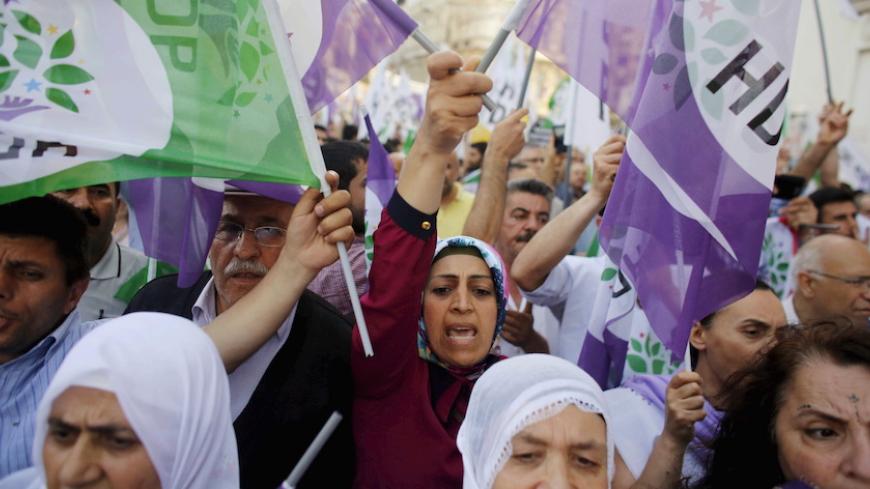 Supporters of pro-Kurdish Peoples' Democratic Party (HDP) shout slogans during a protest against attacks on their party offices, in central Istanbul, Turkey, May 18, 2015. Simultaneous bomb blasts hit the offices of the pro-Kurdish party in two cities in southern Turkey on Monday, three weeks before a parliamentary election, attacks which a party leader blamed on President Tayyip Erdogan. HDP officials said the blasts were the latest in a string of some 60 assaults against the party in the run-up to polling