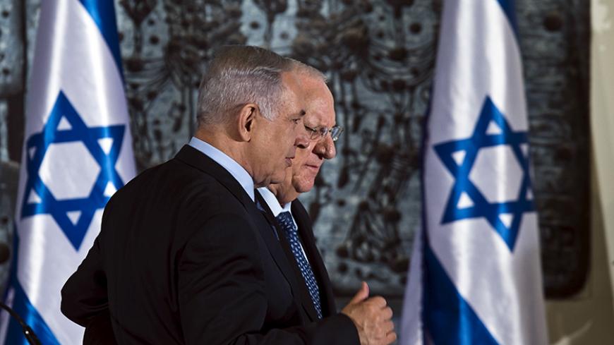 Israel's President Reuven Rivlin (rear) walks with Prime Minister Benjamin Netanyahu (front) before a group photo with ministers of the new Israeli government, in Jerusalem May 19, 2015. REUTERS/Nir Elias       TPX IMAGES OF THE DAY      - RTX1DMGX