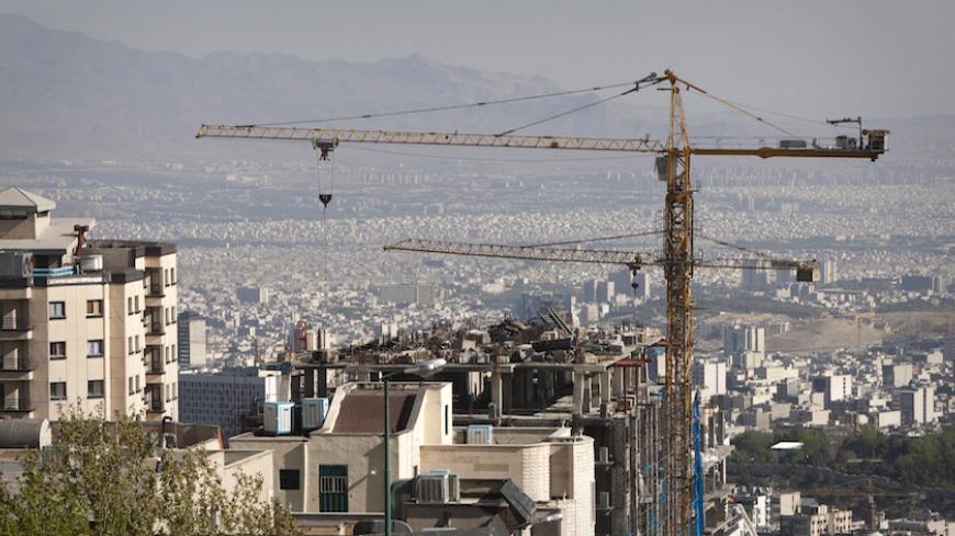 EDITORS' NOTE: Reuters and other foreign media are subject to Iranian restrictions on their ability to report, film or take pictures in Tehran. 

Construction cranes work on a high rise buildings in the foothills of the Alborz mountains in north Tehran April 15, 2010. President Mahmoud Ahmadinejad has asked 5 million Tehranis to evacuate the capital since they know their sprawling metropolis is due for a massive earthquake. When the last major earthquake hit, in 1831, Tehran was tiny compared to the metro