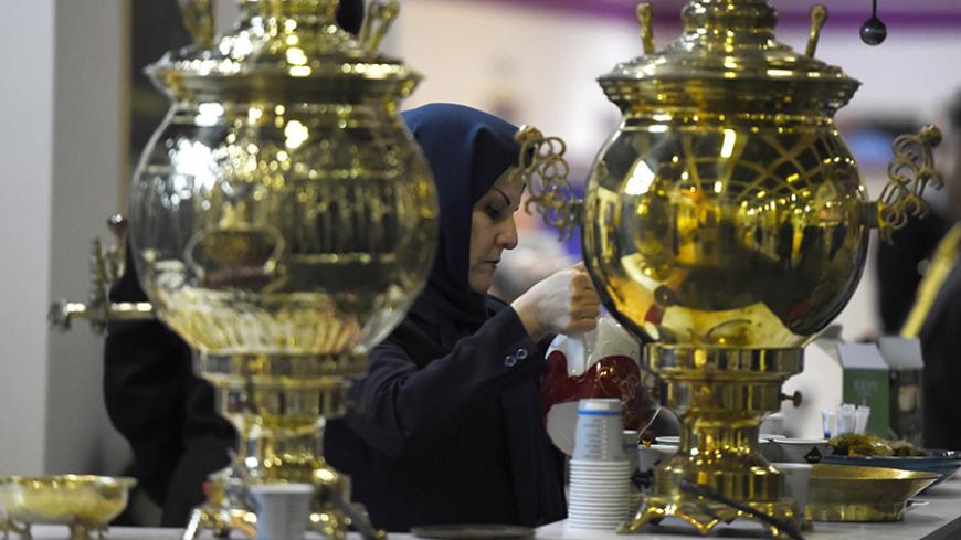 A woman prepares tea at a booth representing Iran at the 49th International Tourism Fair (ITB Berlin 2015) in Berlin on March 4, 2015. 10 096 exhibitors from 186 countries attend the fair that runs until March 8, 2015 in the German capital. AFP PHOTO / TOBIAS SCHWARZ        (Photo credit should read TOBIAS SCHWARZ/AFP/Getty Images)
