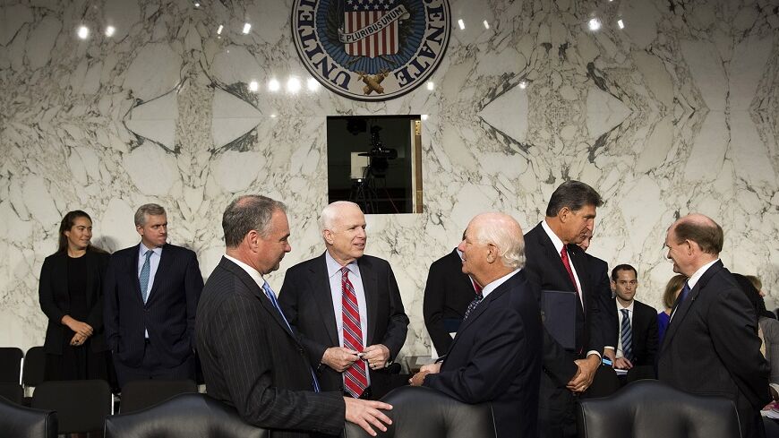 Senators John McCain (R-AZ) (center), Tim Kaine (D-VA) and Ben Cardin (D-MD) (right) speak before Chairman of the Joint Chiefs General Martin E. Dempsey, John Kerry, U.S. secretary of state, and Charles 'Chuck' Hagel, secretary of defense, arrive to present the administration's case for U.S. military action against Syria to a Senate Foreign Relations Committee hearing on September 3, 2013. President Barack Obama on Tuesday urged quick congressional action authorizing the use of military force against Syria 