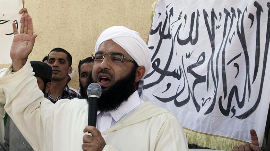 Moroccan Salafist preacher Hassan al-Kettani speaks during a demonstration against an anti-Islam film made in the U.S. that mocks the Prophet Mohammad outside a mosque in the impoverished Rahma neighbourhood of Sale, September 21, 2012. The banner reads, "There is only one God and Mohammad is his prophet". REUTERS/Stringer (MOROCCO - Tags: RELIGION CIVIL UNREST) - RTR3890E