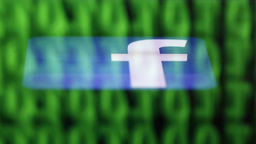 A Facebook logo on an Ipad is reflected among source code on the LCD screen of a computer, in this photo illustration taken in Sarajevo June 18, 2014.  Ireland's High Court on Wednesday asked the European Court of Justice (ECJ) to review a European Union-U.S. data protection agreement in light of allegations that Facebook shared data from EU users with the U.S. National Security Agency.   REUTERS/Dado Ruvic  (BOSNIA AND HERZEGOVINA - Tags: CRIME LAW BUSINESS POLITICS) - RTR3UH6G