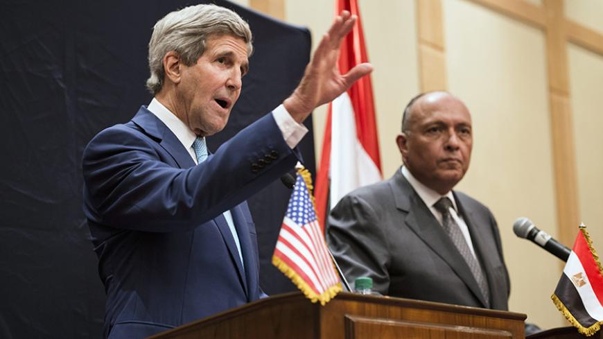 Egypt's Foreign Minister Sameh Shoukri (R) listens as U.S. Secretary of State John Kerry speaks about Iraq during a joint news conference in Cairo June 22, 2014. Kerry said on Sunday the United States wanted Iraqis to find an inclusive leadership to contain a sweeping Islamist insurgency but Washington would not pick or choose who rules in Baghdad. Kerry was speaking at the start of a Middle East tour after talks in Cairo with Egypt's new President Abdel Fattah al-Sisi which covered Western concerns over Eg